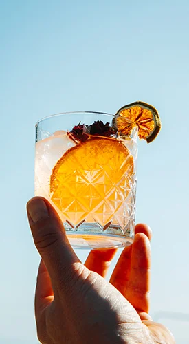 Premium orange cocktail made with Suza T.B. liqueurs, garnished with a slice of orange and dried citrus