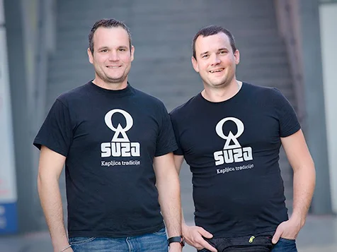 Suza T.B. craft distillery founders wearing black t-shirts with the brand logo.