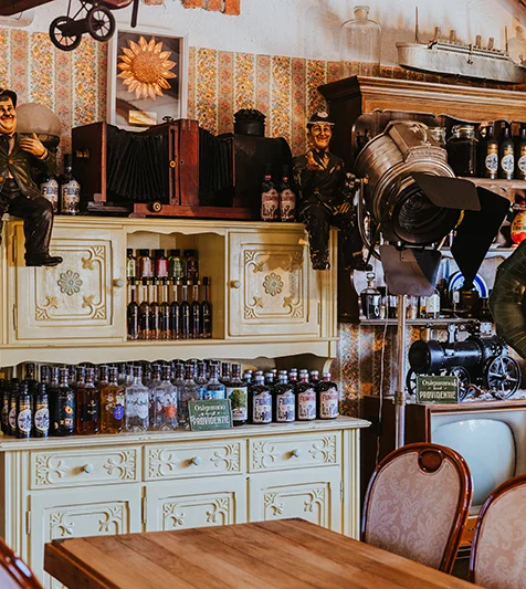 Interior of the Suza T.B. tasting room with bottles of brandies, liqueurs, and gin on a rustic cabinet